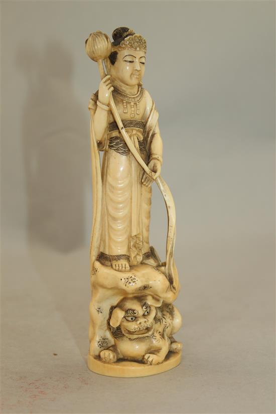 A Japanese ivory group of an immortal and a shi-shi, early 20th century, 18cm